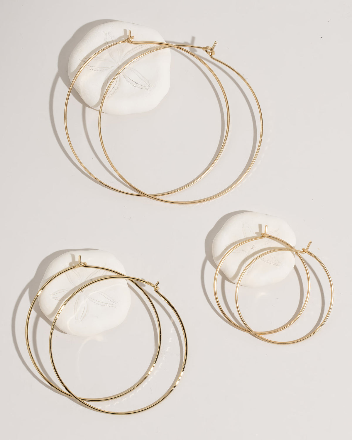 Gold hoop earrings collection display showing all styles and sizes