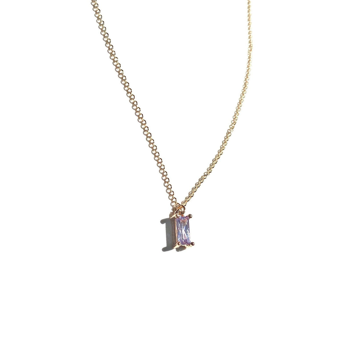 The Celia Necklace by LLUME Jewelry showcases a rectangular lilac gemstone pendant in a minimalist gold vermeil setting, photographed against a white background.