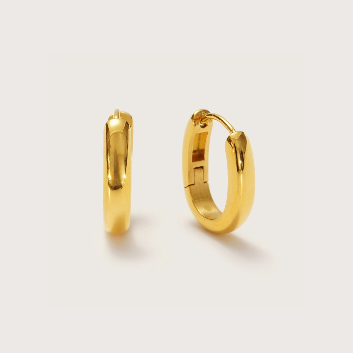Gold Oval Huggies with elongated oval hoop design