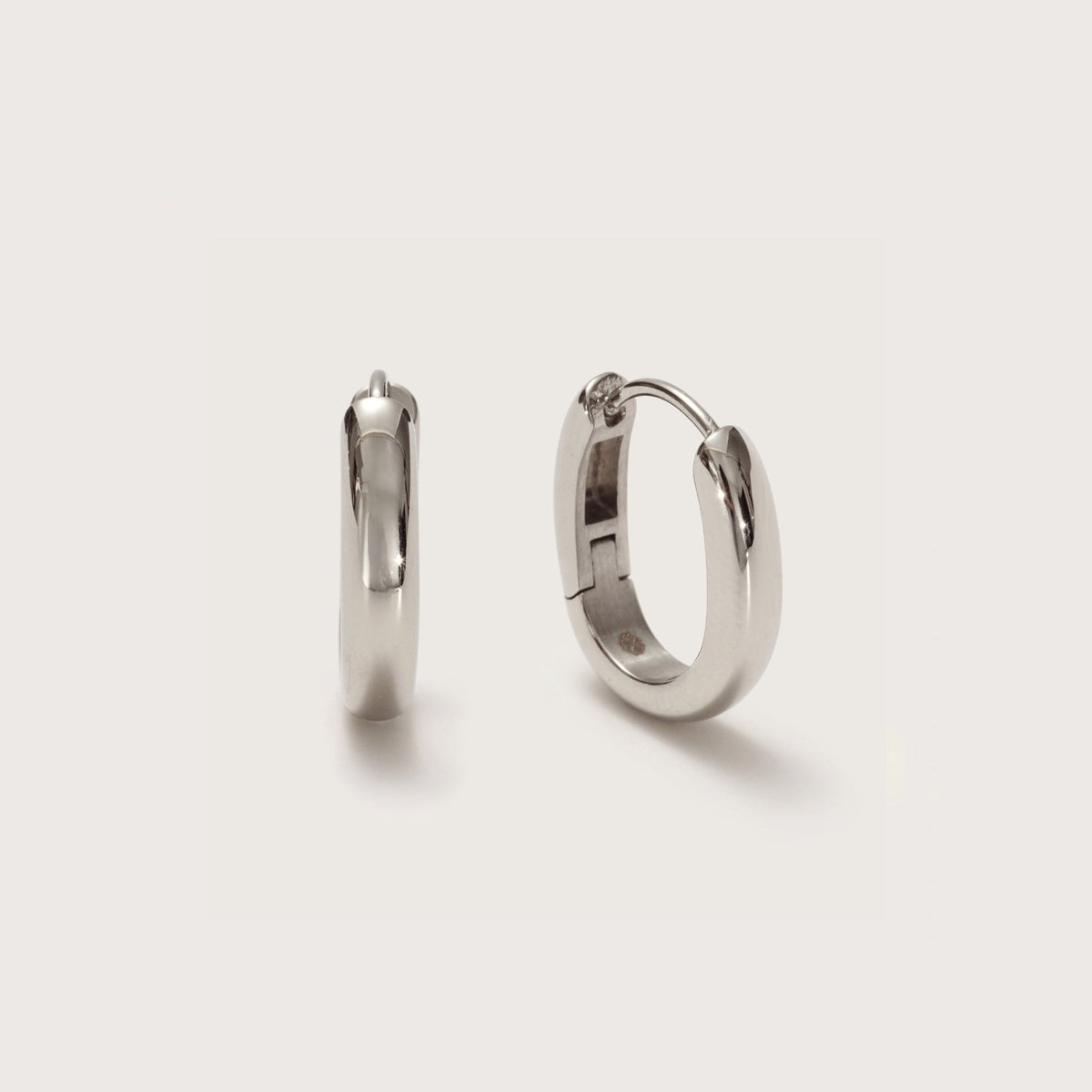 Women Polished Oval Huggie Hoop Earrings in silver tone
