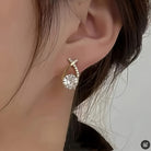 Earrings with golden cross and zirconia