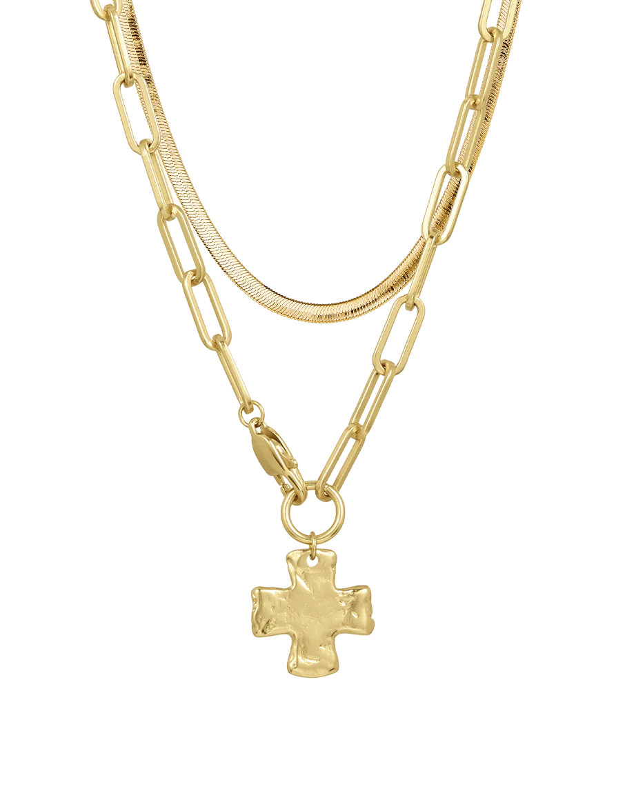 Layered gold necklaces with a cross pendant