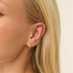 Gold Twisted Huggies styled on ear