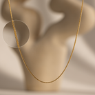 Gold box chain on a neutral background