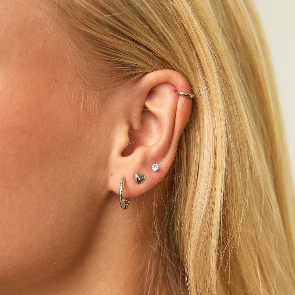 Silver Twisted Huggies styled on ear