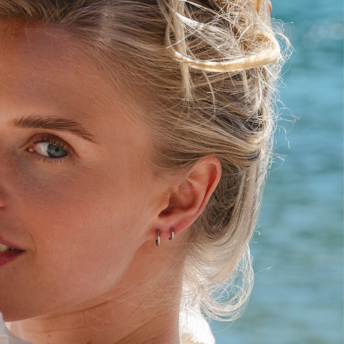 Silver Ultimate Huggies 8mm worn in lifestyle setting