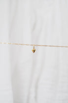 The LLUME Jewelry Build a Charm Necklace features a delicate gold chain with a small heart pendant—perfect for layering or personalizing with your favorite gold-filled charms.