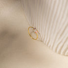 The Duo Marquise Baguette Ring gleams atop a textured cream fabric, highlighting the elegance and craftsmanship of this handmade jewelry piece.
