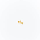 A small gold infinity pendant by LLUME Jewelry, designed with a loop for adding to the Build a Charm Necklace, is shown on a plain white background.