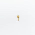 A small gold key charm with a round head and jagged edge rests on a plain white background—ideal for personalizing your jewelry or adding to LLUME Jewelry’s Build a Charm Necklace with other gold filled charms.