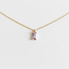 The Celia Necklace by LLUME Jewelry is a delicate gold vermeil piece featuring a small rectangular lilac gemstone pendant, elegantly showcased on a plain white background.
