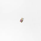 The LLUME Jewelry Build a Birthstone Necklace features a small rectangular gold pendant with a central purple gemstone, elegantly photographed on a plain white background.