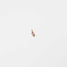 The Build a Birthstone Necklace by LLUME Jewelry features a small gold pendant with a purple gemstone, ideal for custom charm or birthstone necklaces, shown against a plain white background.
