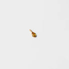 A small gold teardrop-shaped pendant from LLUME Jewelry’s Build a Birthstone Necklace collection, ideal for custom charm necklaces, shown on a plain white background.