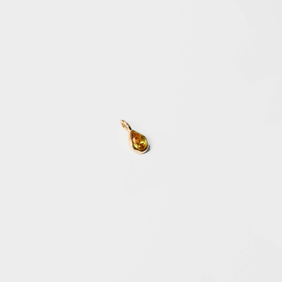 A small gold teardrop-shaped pendant from LLUME Jewelry’s Build a Birthstone Necklace collection, ideal for custom charm necklaces, shown on a plain white background.