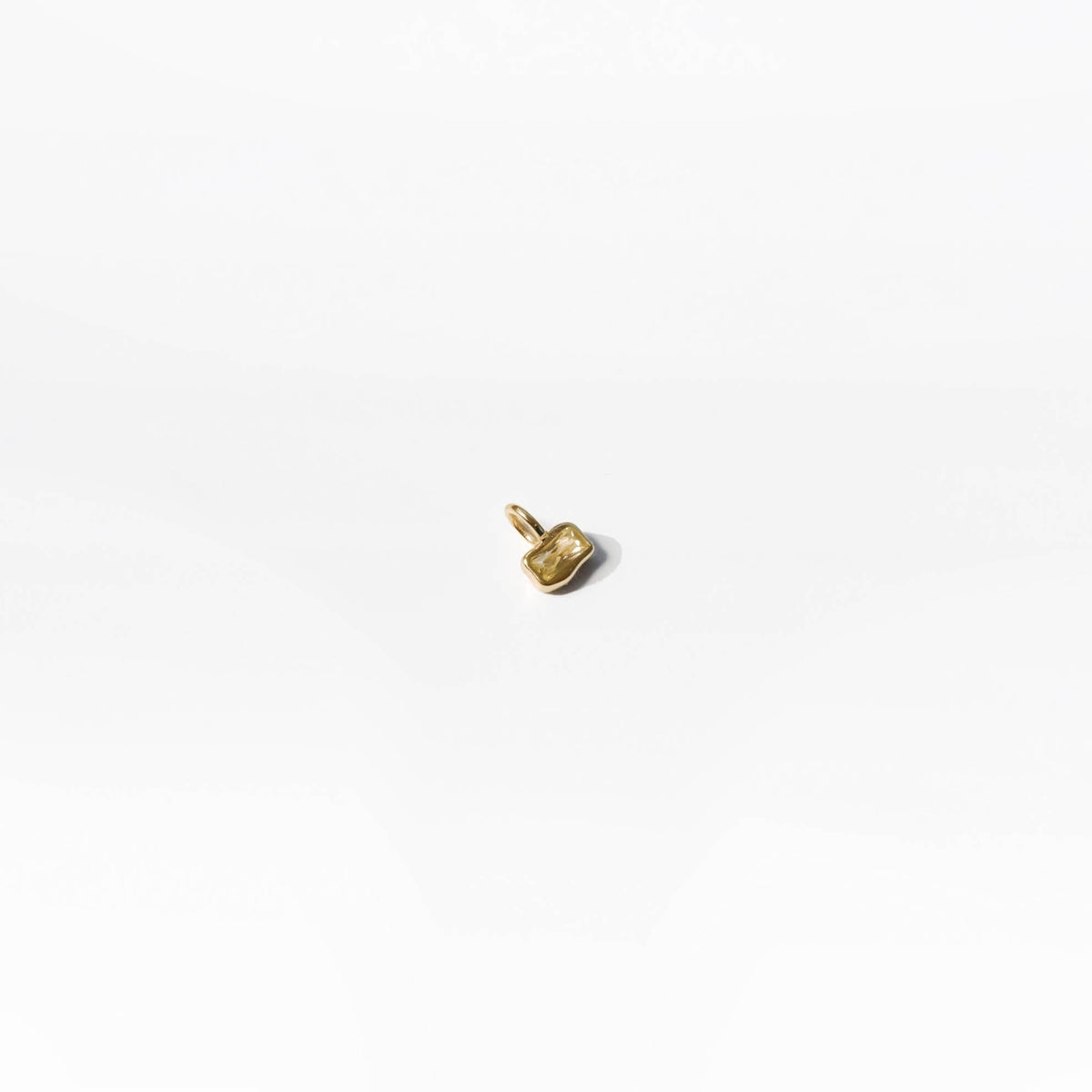 The Build a Birthstone Necklace by LLUME Jewelry features a small, gold-plated charm pendant with an irregular organic shape and a top loop, shown on a plain white background.