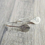 Sterling silver dandelion teardrop dangle earrings with hook closure.